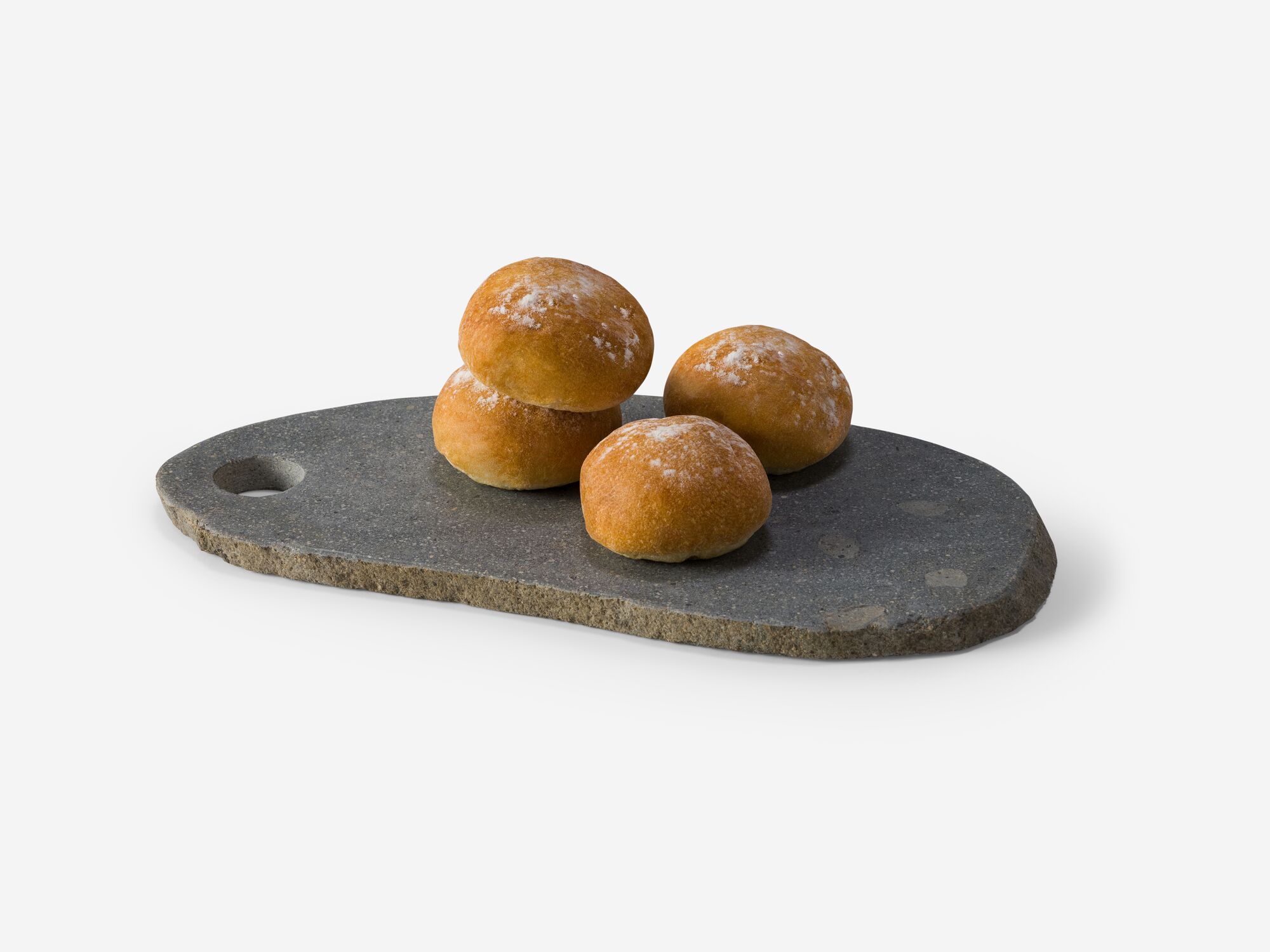 Large natural stone platter with buns on it angle view